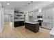 Modern kitchen featuring gray cabinets, stainless appliances, an island with quartz countertops at 2662 Sledge Rd, Louisburg, NC 27549