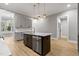 Kitchen with gray cabinets, stainless steel appliances, island with quartz countertops and stainless dishwasher at 2662 Sledge Rd, Louisburg, NC 27549