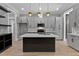 Open kitchen featuring gray cabinets, stainless appliances, and an island with quartz countertops at 2662 Sledge Rd, Louisburg, NC 27549