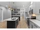 Modern kitchen features gray cabinets, quartz countertops, stainless appliances and custom shelving at 2662 Sledge Rd, Louisburg, NC 27549
