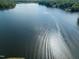 Scenic lake view with a boat leaving wake trails on the water's surface at 2662 Sledge Rd, Louisburg, NC 27549