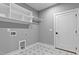 Efficient laundry room with upper shelving, a hanging rod, and a stylish tile floor at 2662 Sledge Rd, Louisburg, NC 27549