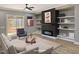 Cozy living room with modern fireplace, custom shelving, and comfortable seating arrangement at 2662 Sledge Rd, Louisburg, NC 27549