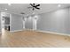 Spacious living room featuring neutral gray walls, and light wood-look flooring, with a ceiling fan at 2662 Sledge Rd, Louisburg, NC 27549
