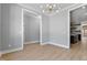 Open living room showcasing modern chandelier and doorways to other rooms at 2662 Sledge Rd, Louisburg, NC 27549