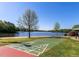 Lakeside view featuring a shuffleboard court, beach, and calm waters at 2662 Sledge Rd, Louisburg, NC 27549