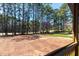 Expansive backyard view framed by a wooden deck railing and lush trees at 2662 Sledge Rd, Louisburg, NC 27549