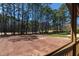 Lush backyard view framed by a wooden deck railing and mature trees at 2662 Sledge Rd, Louisburg, NC 27549