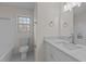 Updated bathroom with modern vanity, new toilet, and tiled floor at 302 Ellen Dr, Knightdale, NC 27545