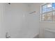 Clean bathroom with a shower/tub combo and window at 302 Ellen Dr, Knightdale, NC 27545