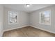 Bright bedroom featuring wood-look floors and two windows at 302 Ellen Dr, Knightdale, NC 27545