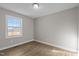 Simple bedroom with wood-look flooring and large window at 302 Ellen Dr, Knightdale, NC 27545