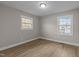 Spacious bedroom with two windows and wood-look floors at 302 Ellen Dr, Knightdale, NC 27545