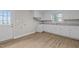 Renovated kitchen with white cabinets, new appliances, and vinyl flooring at 302 Ellen Dr, Knightdale, NC 27545