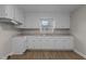 Modern kitchen with white cabinets, updated countertops and flooring at 302 Ellen Dr, Knightdale, NC 27545