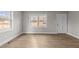 Hardwood floor living room with neutral walls and plenty of natural light at 302 Ellen Dr, Knightdale, NC 27545