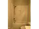 Bathroom showcasing tub with showerhead and tiled wall at 318 Hinton St, Apex, NC 27502