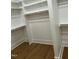 Wood floors with ample storage space featuring rods and shelves in this walk-in closet at 318 Hinton St, Apex, NC 27502