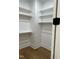 Walk-in closet with wood floor, ample storage space featuring rods and shelves for optimal organization at 318 Hinton St, Apex, NC 27502
