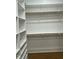 Spacious walk-in closet featuring wood floors, rods, and shelving for optimized home storage at 318 Hinton St, Apex, NC 27502