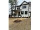 Beautiful two-story home boasting white siding, black accents, a welcoming porch, and a well-manicured front yard at 318 Hinton St, Apex, NC 27502