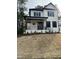 Charming two-story home with a covered porch, black accents, and a professionally landscaped front yard at 318 Hinton St, Apex, NC 27502