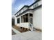 Side view of a white house showcasing a screened porch at 318 Hinton St, Apex, NC 27502