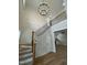 Grand foyer with soaring ceilings, hardwood floors, elegant chandelier, and staircase with decorative iron railing at 318 Hinton St, Apex, NC 27502