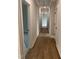 Hallway with hardwood floors and white trim at 318 Hinton St, Apex, NC 27502