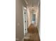 Hallway with hardwood flooring and white molding, showcasing natural light and access to various rooms at 318 Hinton St, Apex, NC 27502