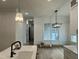 Well-lit kitchen and dining area boast modern lighting and ample space for cooking and entertaining at 318 Hinton St, Apex, NC 27502