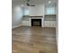Bright living room with a fireplace, built-in shelving, hardwood floors, and recessed lighting at 318 Hinton St, Apex, NC 27502