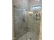 Modern glass-enclosed shower with sleek fixtures and tiled walls for a luxurious bathing experience at 318 Hinton St, Apex, NC 27502