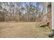Yard with steps leading to a wooded area at 3928 Mike Levi Ct, Raleigh, NC 27610