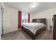 Bedroom featuring a large bed, carpeted floors and window at 3928 Mike Levi Ct, Raleigh, NC 27610