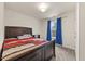 Bedroom with carpeted floors, large bed and window with coverings at 3928 Mike Levi Ct, Raleigh, NC 27610