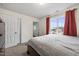 Bedroom features a bed, closet doors, carpet and window for natural light at 3928 Mike Levi Ct, Raleigh, NC 27610