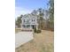Two-story gray house with white trim, front porch, and driveway at 3928 Mike Levi Ct, Raleigh, NC 27610