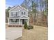 Two-story gray house with white trim, front porch, and driveway at 3928 Mike Levi Ct, Raleigh, NC 27610