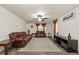 Living room with brown leather couches and a large area rug at 3928 Mike Levi Ct, Raleigh, NC 27610