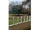 View of backyard with large tree and fence at 4519 Edwards Mill Rd # J, Raleigh, NC 27612