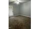 Bright bedroom featuring carpet and door to outside at 4519 Edwards Mill Rd # J, Raleigh, NC 27612