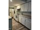 White kitchen cabinets, granite counters, and appliances at 4519 Edwards Mill Rd # J, Raleigh, NC 27612
