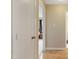 Hallway with light walls and wood flooring, leading to a bedroom at 5112 Flint Ridge Pl, Raleigh, NC 27609
