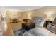 Bright living room features hardwood floors, comfortable seating, and a view into the kitchen at 5112 Flint Ridge Pl, Raleigh, NC 27609