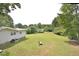 Large backyard with a view of neighboring houses at 5617 Laurel Crest Dr, Durham, NC 27712