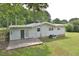 Home's back features a patio and spacious grassy area at 5617 Laurel Crest Dr, Durham, NC 27712