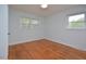 Spacious bedroom with hardwood floors and two windows at 5617 Laurel Crest Dr, Durham, NC 27712