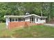 Ranch home with brick and siding exterior, spacious yard, and mature trees at 5617 Laurel Crest Dr, Durham, NC 27712