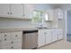 White cabinets, stainless steel appliances, and a double sink at 5617 Laurel Crest Dr, Durham, NC 27712